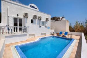 a swimming pool in the backyard of a house at Pension Ptolemeos in Fira