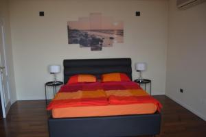 a bedroom with a bed with a colorful blanket at Villa Anna in Brenzone sul Garda