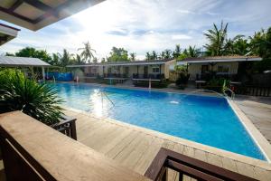 a large swimming pool in front of a house at Anika Island Resort in Bantayan Island