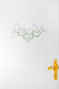 a sign that says excellence smile on a white wall at Casa Marta Capri in Capri