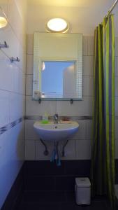 a bathroom with a sink and a mirror at Lion-Suites in Kalyves