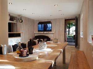 ein Esszimmer mit einem langen Holztisch mit Vasen darauf in der Unterkunft Kashubia Cottage in Przewóz