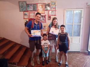 a family posing for a picture while holding up certificates at Karine B&B in Yeghegnadzor