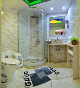 a bathroom with a shower and a toilet and a sink at Casa della Favola Boutique Hotel in Chania