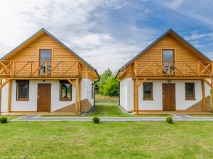 a wooden house with a large yard in front of it at Domki VIP dla rodzin Ustka in Ustka