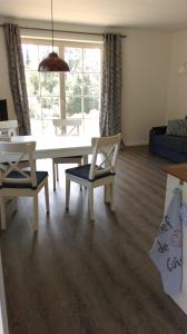 a living room with a table and chairs and a couch at Ferienwohnung Böttcher in Putbus