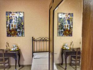 a room with two tables and a bed and two paintings at Bed and Breakfast Pieffe in Frascineto