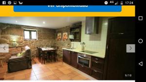 a kitchen with a sink and a table in a room at Casita curbeiros in O Grove