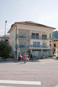 a group of people walking in front of a building at Casa Rosa dei Venti in Nago-Torbole