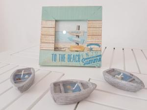three baskets sitting on a table next to a book at Vila Alikaj in Sarandë