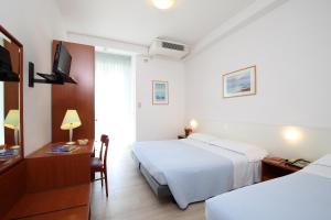 Postel nebo postele na pokoji v ubytování Hotel Caravel