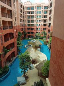 an aerial view of a resort with blue water and straw umbrellas at seven seas by wandee in Jomtien Beach