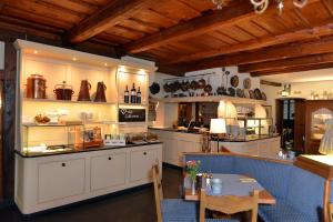 a kitchen with white cabinets and a table in it at Hotel Reichs-Küchenmeister in Rothenburg ob der Tauber