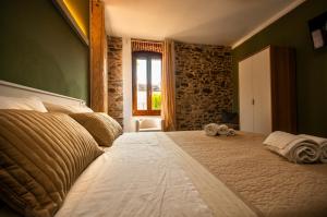 a bedroom with a large bed with towels on it at Case Vacanza Skipper in Pettenasco