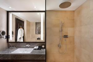 a bathroom with a sink and a shower at The Setai Tel Aviv in Tel Aviv