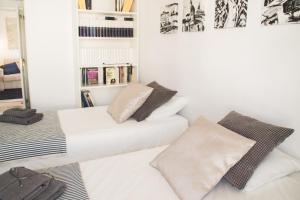a white room with two beds and a mirror at Cozy Apartment Banus in Marbella