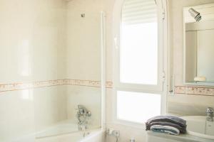a white bathroom with a tub and a sink at Cozy Apartment Banus in Marbella +27 photos