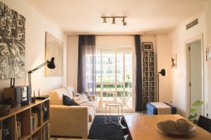 a living room with a couch and a table at Cozy Apartment Banus in Marbella