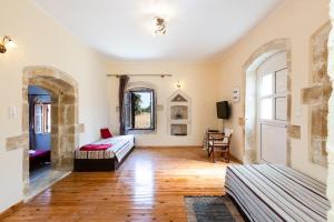 a living room with a bed and a couch at Erato House in Koúfi