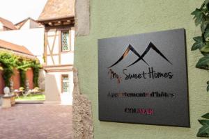 a sign on the side of a building that reads my sweet homes apartmentitals at MY SWEET HOMES - STUDIO "LE CAVEAU" in Colmar