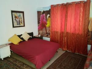 a room with a bed with a red cover at Sunny Apartment in Jerusalem