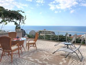 a patio with chairs and a table and the ocean at Apartment Jana in Ulcinj