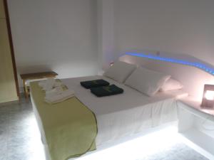A bed or beds in a room at Leros Eleonas Apartments