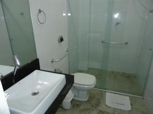 uma casa de banho com um lavatório, um chuveiro e um WC. em Hotel Turista em Belo Horizonte