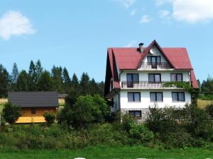 a large white house with a red roof at Dom Sosenek in Kluszkowce +140 photos