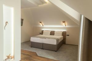 a small bedroom with a bed in a attic at Hugo Hotel in Varna City