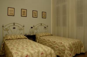 A bed or beds in a room at B&B Le Camelie