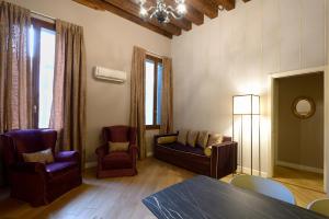 a living room with a couch and chairs and a table at Residence La Fenice in Venice