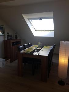 a dining room table with chairs and a skylight at Monteurwohnung Schinderhannes in Miehlen