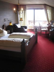 a hotel room with two beds and a living room at Panoramahotel Karwendelhof in Wallgau