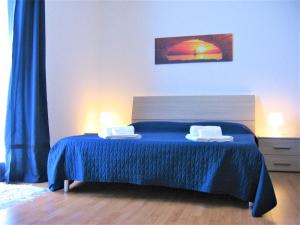 MazzarinoにあるCasa Principe Umbertoのベッドルーム1室(青いシーツとランプ2つ付)