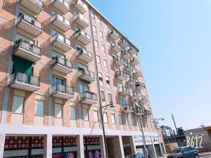 a large brick building with balconies on a street at BB Stay Station in Mestre