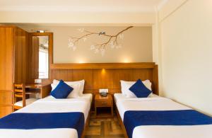 Postel nebo postele na pokoji v ubytování Hotel White Pearl