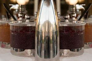 a table with three different types of drinks in jars at Riviera Perdika Hotel in Perdika