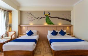 Postel nebo postele na pokoji v ubytování Hotel White Pearl