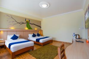 Postel nebo postele na pokoji v ubytování Hotel White Pearl
