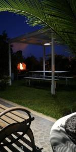 a bench sitting in front of a pavilion at night at Etna Sweet Home in Santa Venerina