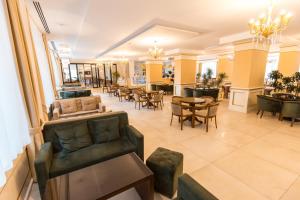 a lobby of a store with chairs and tables at Hotel Turizem Shkelzeni in Kolgecaj