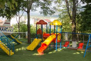 a playground with a slide in a park at Hotel Turizem Shkelzeni in Kolgecaj