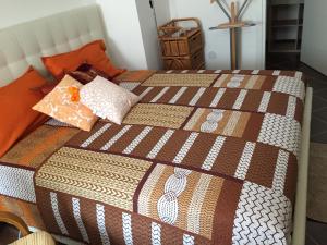 a bed with a blanket and pillows on it at SoleLuna House in Modica