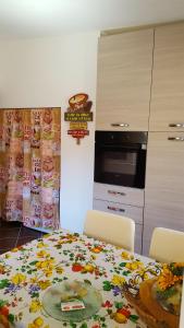 a kitchen with a table with a flower pattern on it at SoleLuna House in Modica +11 photos