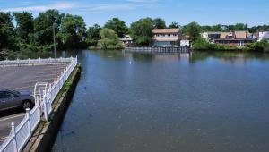 a river with a car parked next to a parking lot at South Bay Motel in Copiague