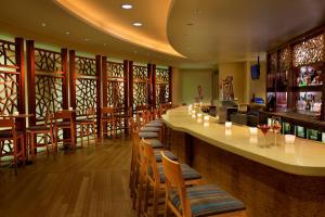 a bar with wooden chairs and a counter in a restaurant at Seaport Hotel® Boston in Boston