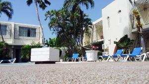 a group of chairs sitting next to a building at Pirate's Inn in Bridgetown