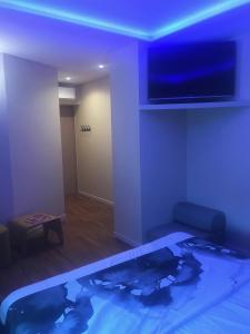 a room with a tv and a swimming pool at chambre suite B&B in Montpellier