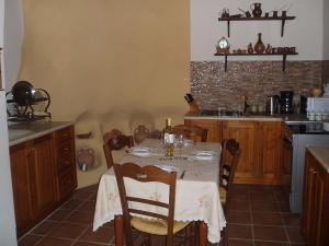 a kitchen with a table with a white table cloth at Ostria's House in Kissamos